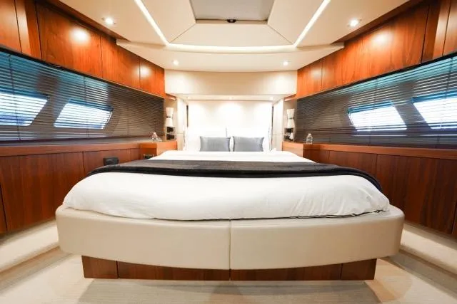 Catch The Wave Yacht Photos Pics Luxurious bedroom interior of 2013 Sunseeker Manhattan 73 yacht with elegant wood paneling.