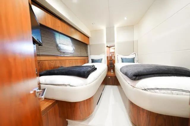 Catch The Wave Yacht Photos Pics Luxurious twin cabin interior of 2013 Sunseeker Manhattan 73 yacht, featuring elegant wood finishes.