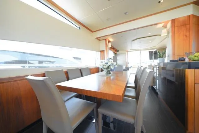Catch The Wave Yacht Photos Pics Luxurious dining area on 2013 Sunseeker Manhattan 73 yacht with elegant wood finishes.