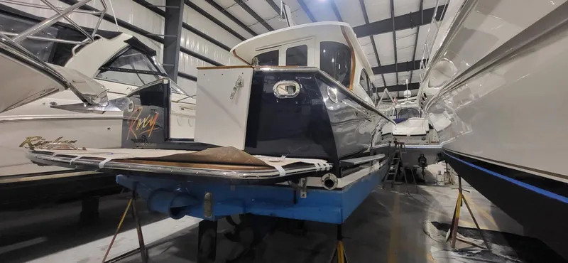  Yacht Photos Pics 2022 Legacy 36 yacht in storage, surrounded by other boats in a warehouse.