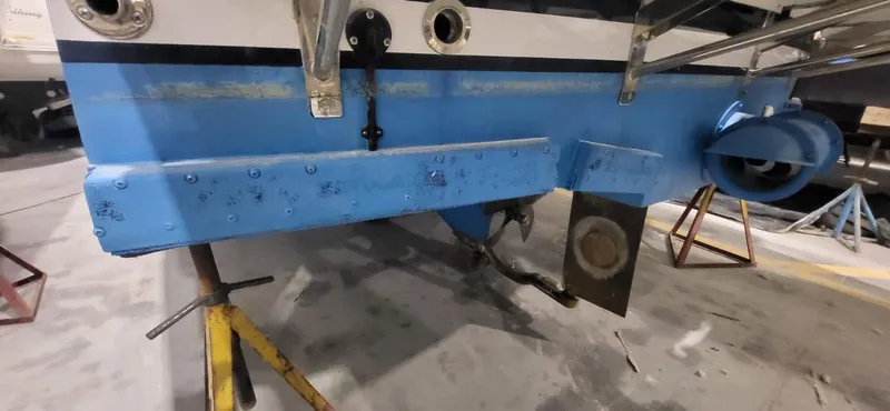  Yacht Photos Pics 2022 Legacy 36 boat hull in dry dock, showing blue paint and support stands.