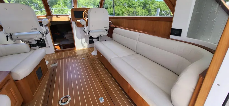  Yacht Photos Pics Interior of 2022 Legacy 36 Legacy yacht with plush seating and wooden flooring.