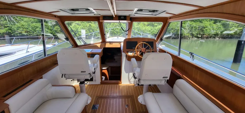  Yacht Photos Pics Interior of 2022 Legacy 36 yacht with wooden accents and plush seating.