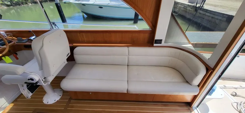  Yacht Photos Pics Luxurious interior of 2022 Legacy 36 boat with white seating and wooden accents.