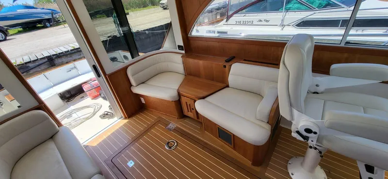  Yacht Photos Pics Luxurious 2022 Legacy 36 yacht interior with plush seating and elegant wood finish.