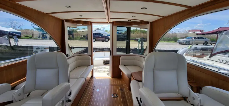  Yacht Photos Pics Interior of 2022 Legacy 36 yacht with luxurious seating and wooden finishes.