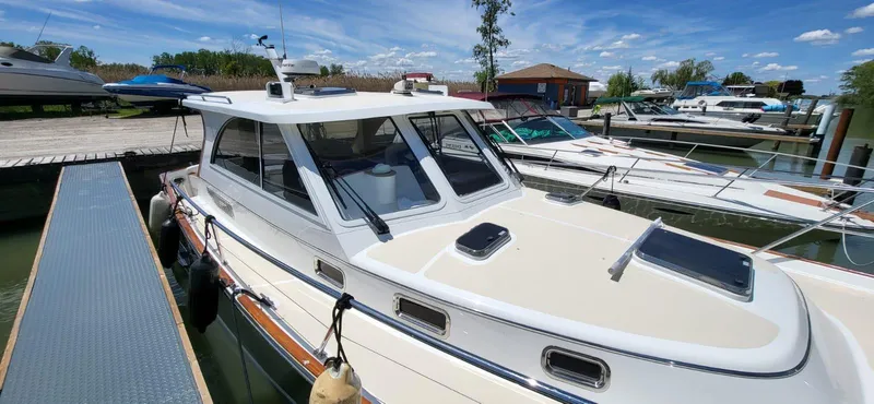  Yacht Photos Pics 2022 Legacy 36 boat docked at marina under clear blue sky.