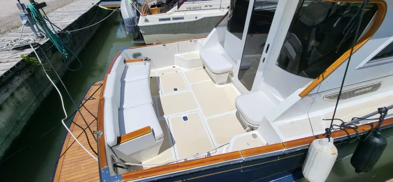  Yacht Photos Pics 2022 Legacy 36 boat with spacious deck and seating at a marina.