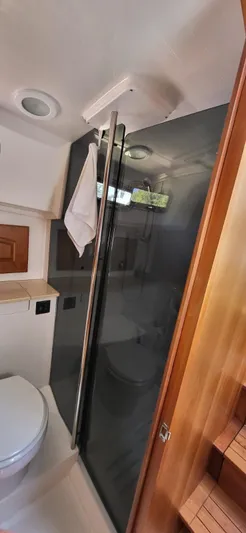  Yacht Photos Pics 2022 Legacy 36 yacht bathroom with modern shower and wooden accents.