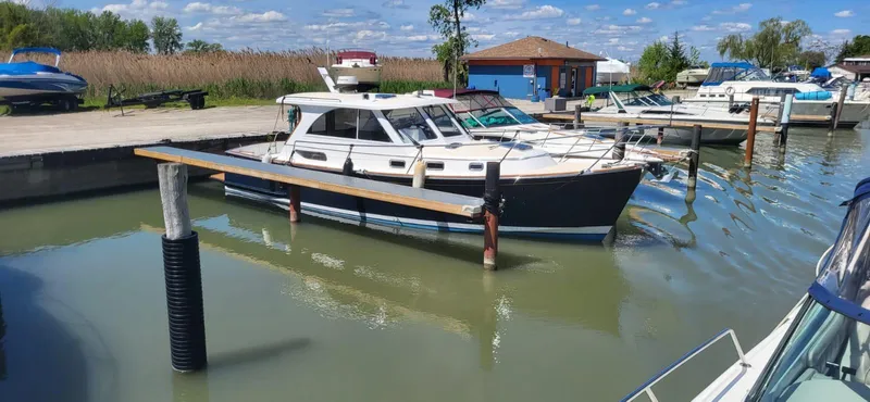  Yacht Photos Pics 2022 Legacy 36 yacht docked in a marina under a clear blue sky.