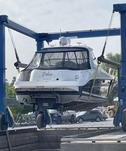  Yacht Photos Pics 2004 Sea Ray Sundancer 460 yacht in dry dock, lifted by a blue crane.