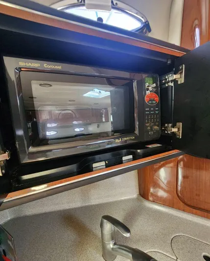  Yacht Photos Pics Microwave in 2004 Sea Ray Sundancer 460 yacht kitchen, featuring Sharp Carousel model.