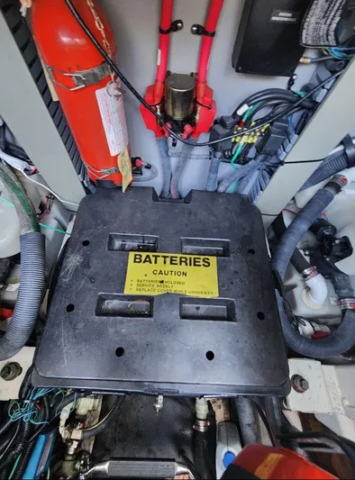  Yacht Photos Pics Battery compartment of a 2004 Sea Ray Sundancer 460 with caution label and fire extinguisher.
