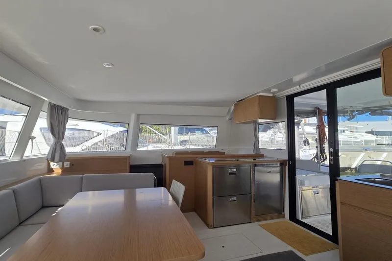  Yacht Photos Pics Modern interior of 2025 Excess 14 catamaran with sleek design and ample natural light.