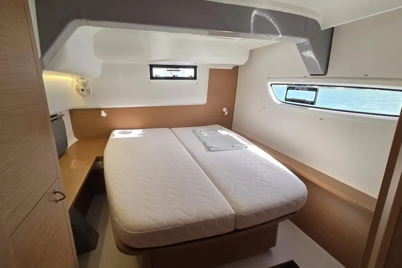  Yacht Photos Pics Luxurious cabin interior of 2025 Excess 14 yacht with double bed and ocean view.