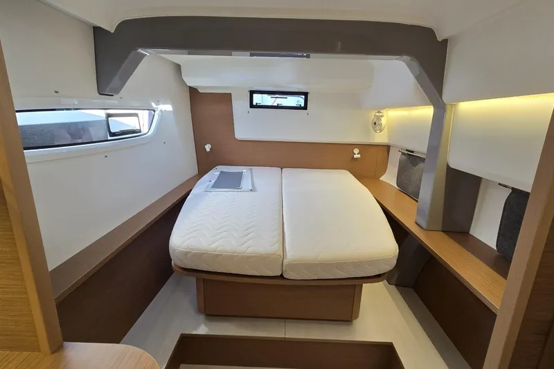  Yacht Photos Pics Luxurious cabin interior of 2025 Excess 14 yacht with modern design and comfortable bedding.