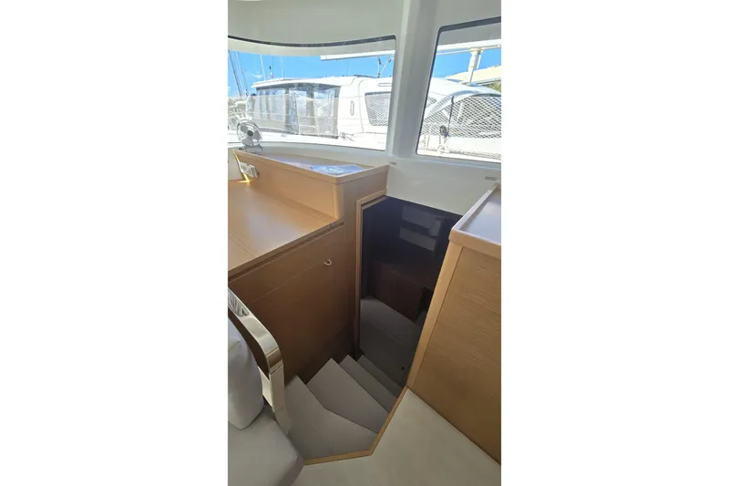 Yacht Photos Pics Interior view of 2025 Excess 14 yacht, featuring wooden stairs and modern design.