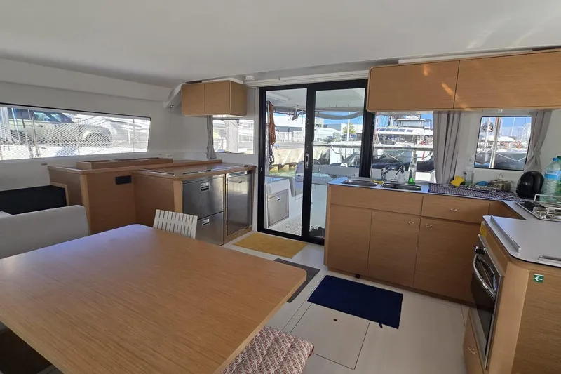  Yacht Photos Pics Modern interior of 2025 Excess 14 yacht with kitchen and dining area.