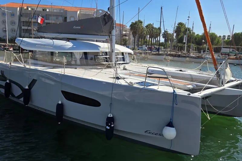  Yacht Photos Pics 2025 Excess 14 catamaran docked in marina, featuring sleek design and modern amenities.