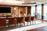 Luxurious dining area on 2022 Amels Custom yacht with elegant decor and ocean view.