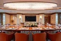 Luxurious dining area on 2022 Amels Custom yacht with elegant table setting and chandelier.