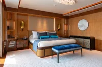 Luxurious Amels Custom 2022 yacht bedroom with elegant decor and modern furnishings.
