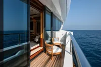 Luxurious 2022 Amels Custom yacht balcony with ocean view and elegant seating.