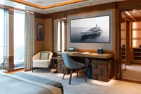 Luxurious interior of 2022 Amels Custom yacht with elegant furnishings and large window views.