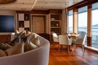 Luxurious Amels Custom 2022 yacht interior with elegant seating, chess table, and ocean view.