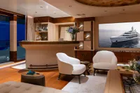 Luxurious yacht interior with elegant bar and seating, featuring Amels Custom 2022 model.