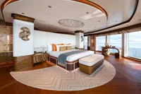 Luxurious 2022 Amels Custom yacht bedroom with elegant decor and panoramic ocean views.
