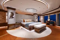 Luxurious 2022 Amels Custom yacht bedroom with elegant decor and ocean views.