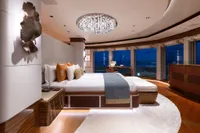 Luxurious 2022 Amels Custom yacht bedroom with elegant decor and ocean views.