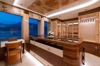 Luxurious interior of 2022 Amels Custom yacht with elegant wood finishes and panoramic windows.