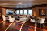 Luxurious yacht interior with elegant seating, chess table, and ocean view, Amels Custom 2022.