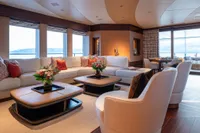 Luxurious interior of 2022 Amels Custom yacht with elegant seating and floral decor.
