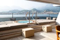 Luxurious Amels Custom 2022 yacht deck with hot tub and scenic coastal view.