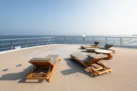 Luxurious 2022 Amels Custom yacht deck with sun loungers overlooking the ocean.