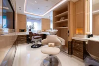 Luxurious yacht interior with modern salon setup, featuring elegant chairs and cabinetry, Amels Custom 2022.