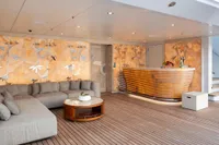 Luxurious Amels Custom 2022 yacht interior with elegant seating and decorative wall art.