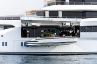 Luxury Amels Custom yacht with crew deploying a tender boat, 2022 model.