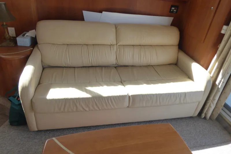 Bee Cee Yacht Photos Pics Beige leather sofa inside 2000 Silverton 42C Cummins yacht, with wooden interior accents.