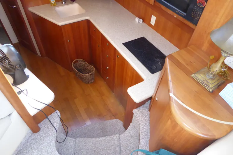 Bee Cee Yacht Photos Pics Interior of 2000 Silverton 42C yacht with wooden cabinetry and modern kitchen amenities.