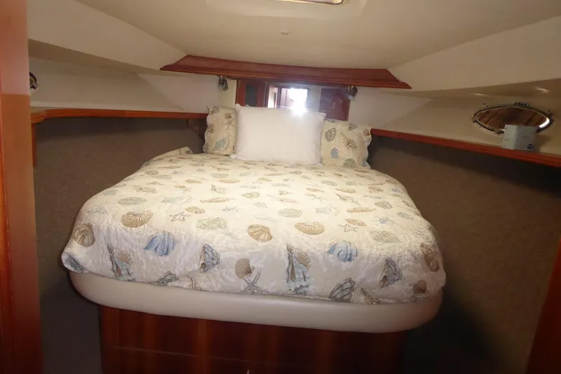 Bee Cee Yacht Photos Pics Cozy bedroom in 2000 Silverton 42C Cummins yacht with seashell-themed bedding.