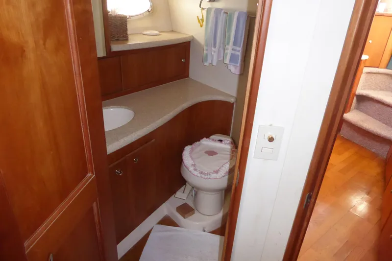 Bee Cee Yacht Photos Pics Bathroom interior of 2000 Silverton 42C Cummins yacht, featuring wooden cabinetry and compact design.