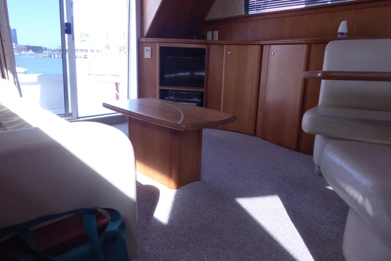 Bee Cee Yacht Photos Pics Interior of 2000 Silverton 42C yacht with wooden cabinetry and seating area.