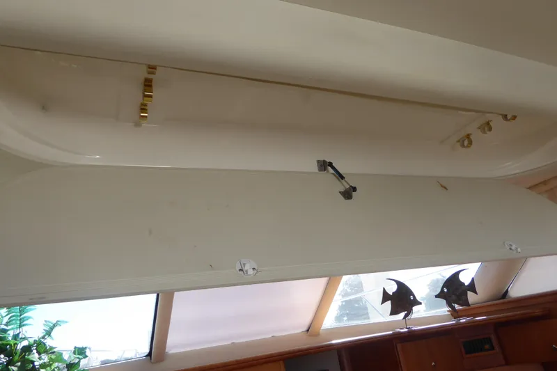 Bee Cee Yacht Photos Pics Open storage compartment in 2000 Silverton 42C Cummins yacht interior, featuring decorative fish accents.