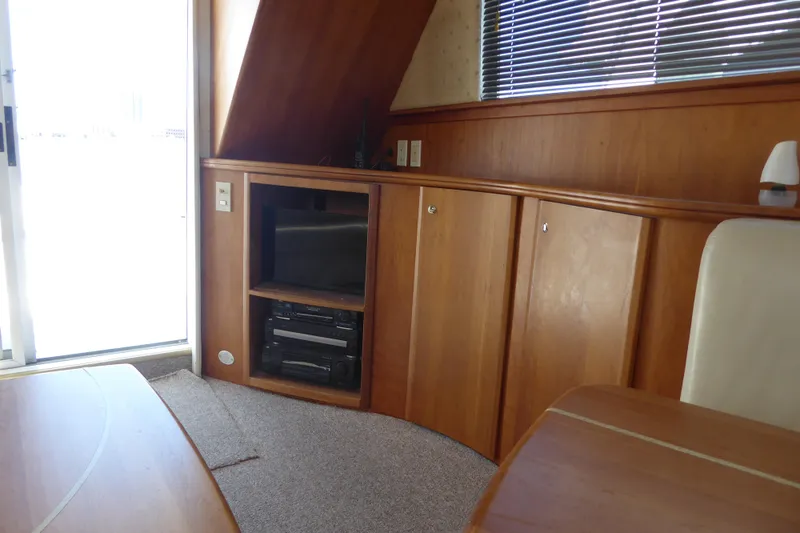 Bee Cee Yacht Photos Pics Interior of 2000 Silverton 42C yacht with wood cabinetry and entertainment center.