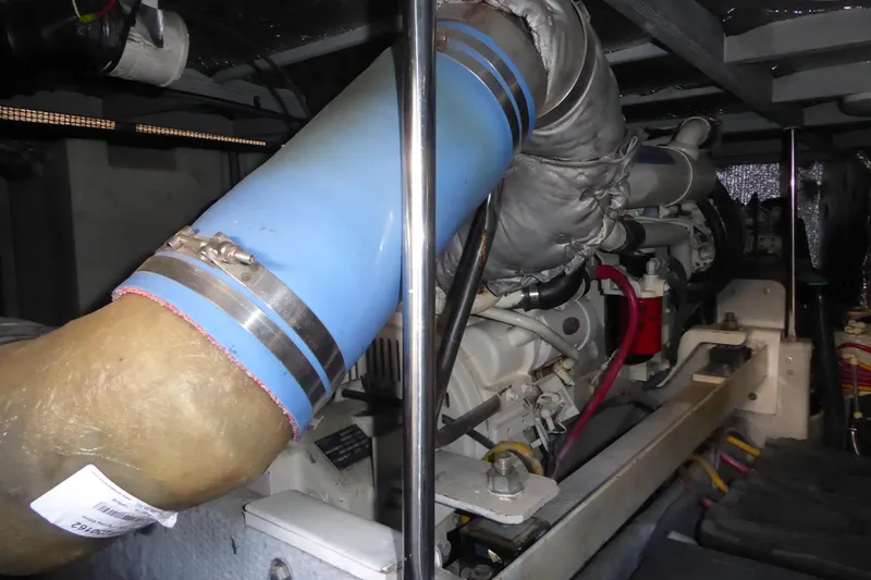 Bee Cee Yacht Photos Pics Engine compartment of 2000 Silverton 42C with Cummins 450 Diesels, featuring blue exhaust pipe.