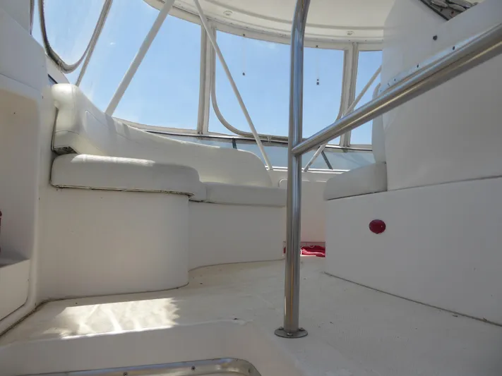 Bee Cee Yacht Photos Pics Interior view of 2000 Silverton 42C yacht with white seating and metal railings.